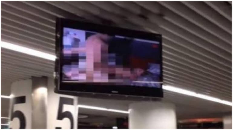 Bemused travelers posted images of screens inside Santos Dumont Airport playing explicit videos. Image: (@reportdailys/Twitter)