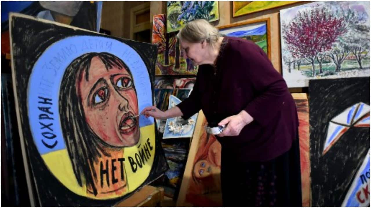 Russian artist Yelena Osipova, 76, makes anti-war placards to protest the conflict in Ukraine, in her home in Saint Petersburg.