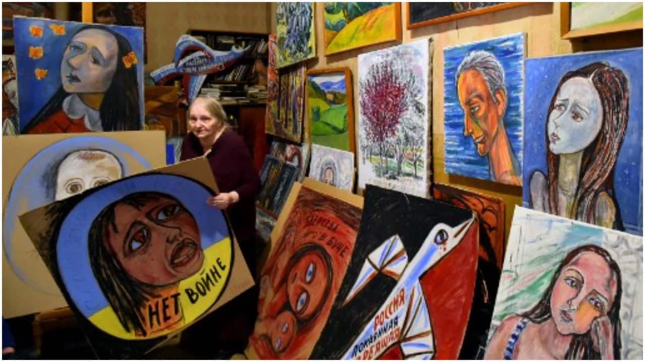 Russian artist Yelena Osipova, 76, and her anti-war placards she made to protest the conflict in Ukraine, in her home in Saint Petersburg.a
