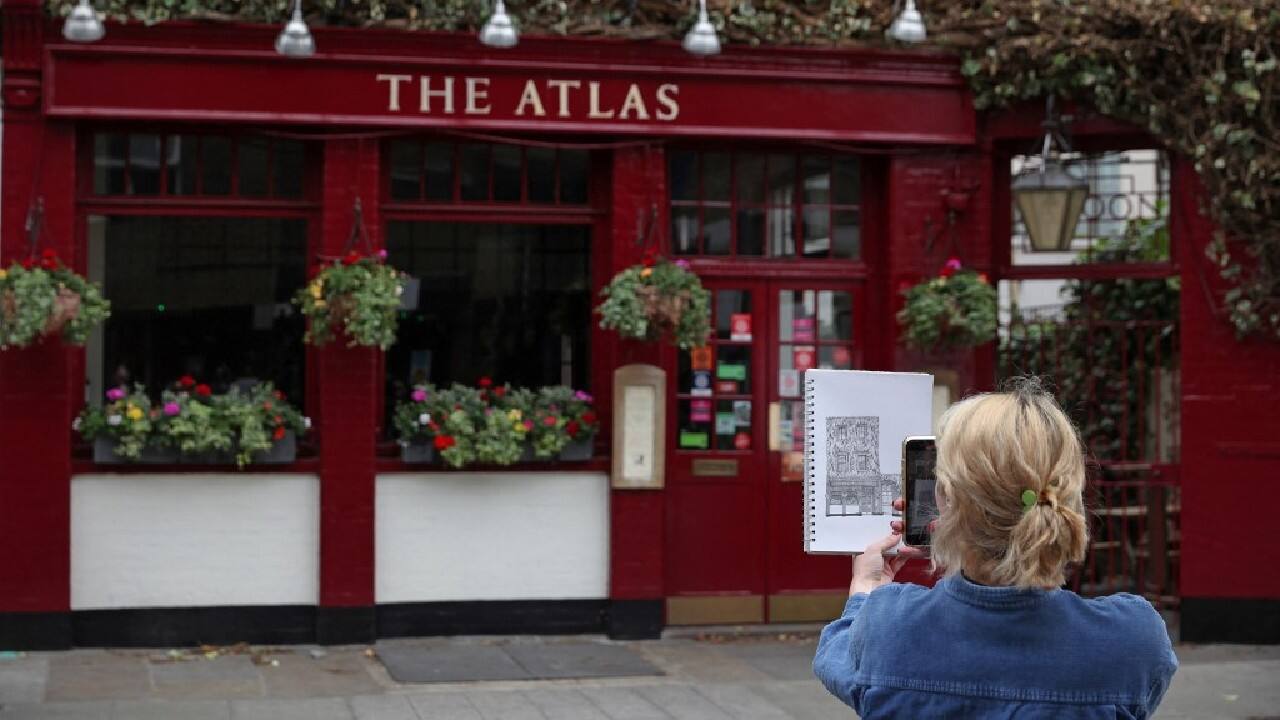 Wood's drawings get thousands of likes on Instagram and TikTok, where she posts short videos about the process, then holds up the finished sketch in front of the pub. The freelance artist had always drawn some pictures of pubs to sell at Christmas markets. But when she announced her plan and asked for commissions to draw the capital's pubs, &quot;things went a little bit crazy&quot;, she admitted. (Image: AFP)