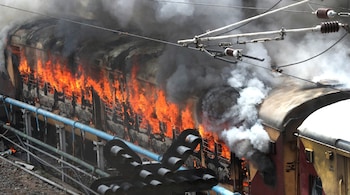 Rail coaches were set on fire by Agnipath protesters in Bihar on Saturday. - Reuters