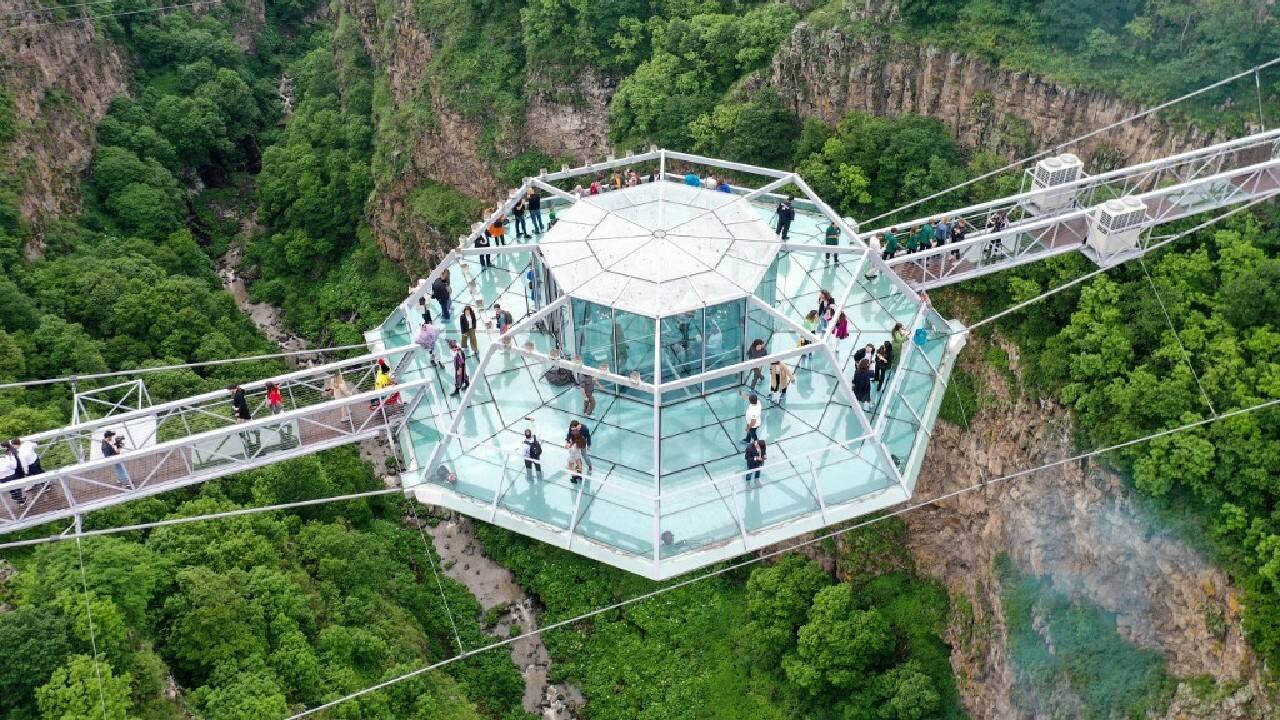People attend the opening ceremony 240-meter long glass bridge over the Tsalka canyon, with a diamond-shaped café in the middle outside the city of Tsalka some 100 km from Tbilisi. (Image: AFP)