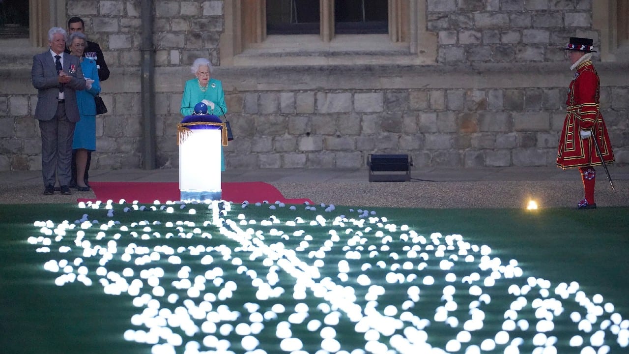 Britain's Queen Elizabeth II triggered the lighting of a chain of ceremonial beacons on June 2 as part of festivities bringing an end to an eventful first day of celebrations for the monarch's Platinum Jubilee. (Image: AP)