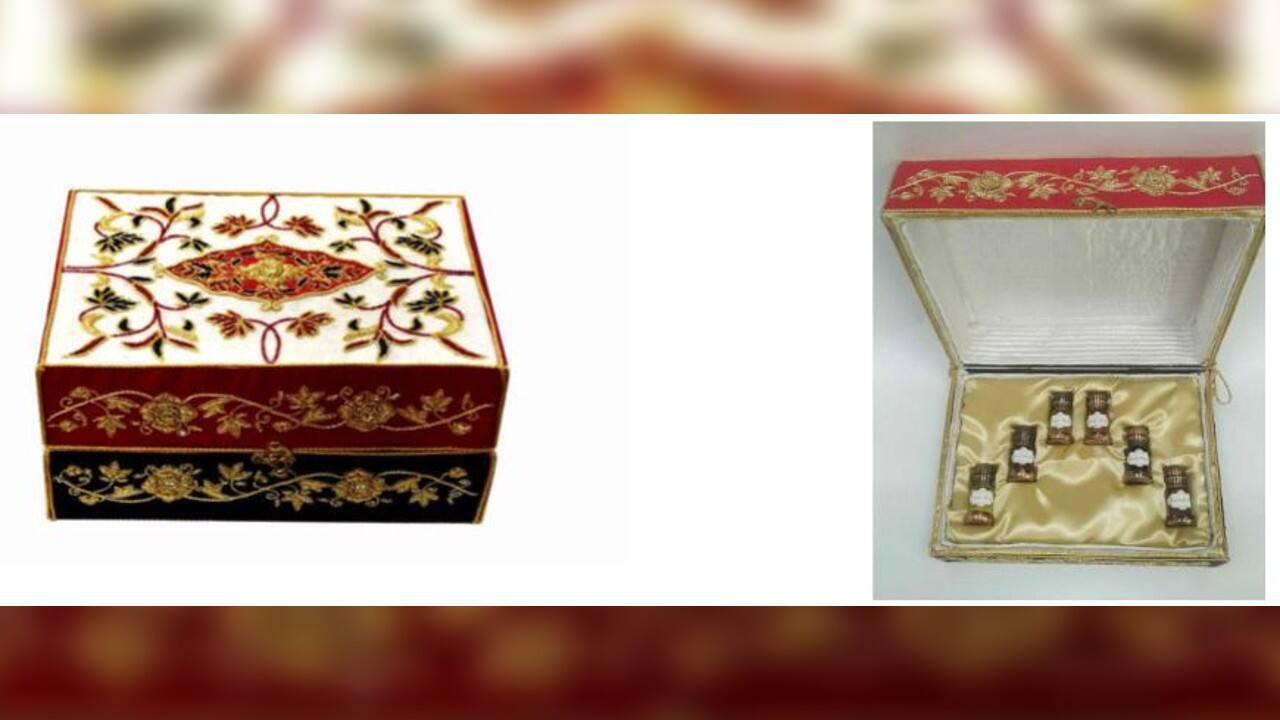 PM Modi gifted &lsquo;Itr bottles in Zardozi box&rsquo; to French President Emmanuel Macron. The carrier box has been crafted in Lucknow, Uttar Pradesh. The zari zardozi box has been embroidered on khadi silk and satin tissue in colours of the French National Flag. The motifs are traditional Indo-Persian, lotus flowers hand-embroidered with metal wire in blue and a pendant used in Kashmiri carpets and motifs from Awadhi architecture. The box included Attar Mitti, Jasmine oil, Attar Shamama, Attar Gulab, Exotic Musk and Garam Masala. (Source: ANI)