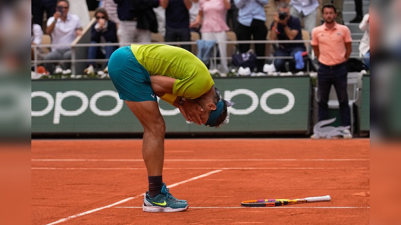 When it ended with a down-the-line backhand from Nadal, he chucked his racket to the red clay he loves so much and covered his face with the taped-up fingers on both of his hands. (Source: AP)