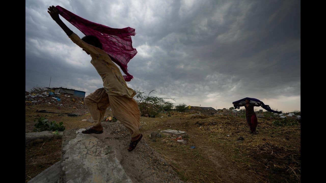 1.Nomadic Gujjar girls hold their scarves over their heads, as rain clouds hover in Jammu, India, Monday, May 30, 2022. The monsoon rains which usually hit India from June to September are crucial for farmers whose crops feed hundreds of millions of people. (AP Photo/Channi Anand)