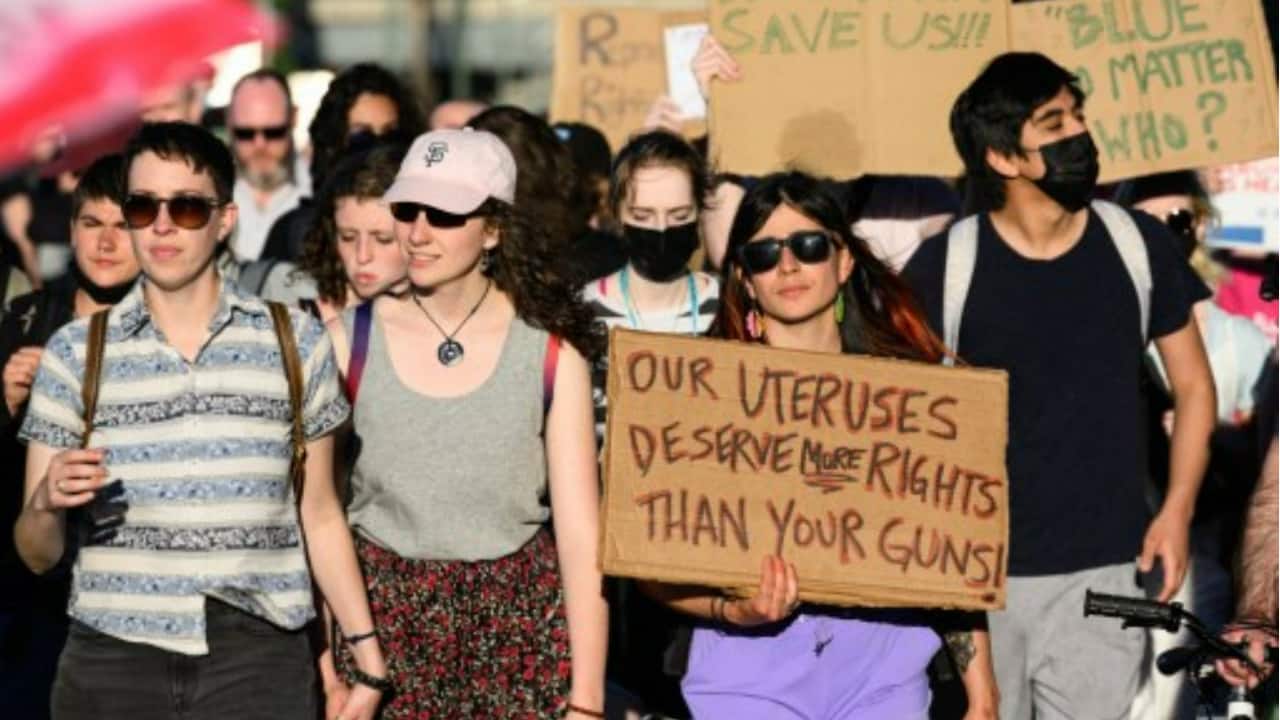 People march across the Hawthorne Bridge to protest the Supreme Court's decision to overturn Roe v. Wade in Portland, Oregon.