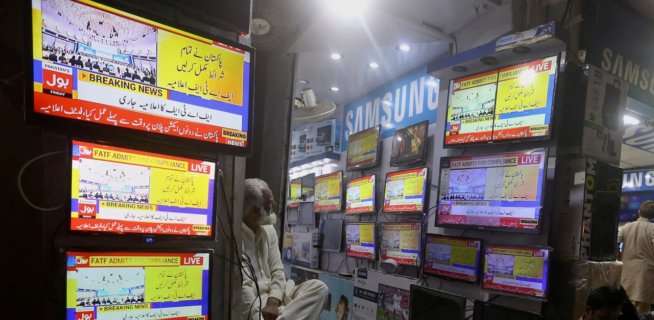 Locals in Karachi tracking news channels on June 17, awaiting the FATF decision (AP Photo/Fareed Khan)