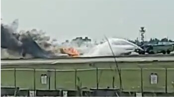 Visuals shared online show firefighters dousing the flames after a Red Air flight caught fire (Image credit: emalevin/Twitter)