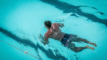 For the pull buoy drill, press the pull buoy between your thighs and use your arms to swim the desired or prescribed distance. Slowly add side breathing to the drill. (Representational image: Mark Williams via Unsplash)