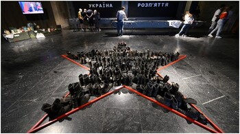 People visit the exhibition on the ongoing war "Ukraine – Crucifixion" at the National Museum of the History of Ukraine in the Second World War, in Kyiv.