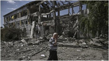 A local resident reacts in front of a destroyed school after a strike in the city of Bakhmut, eastern Ukrainian region of Donbas on June 8, 2022. (Image: AFP)