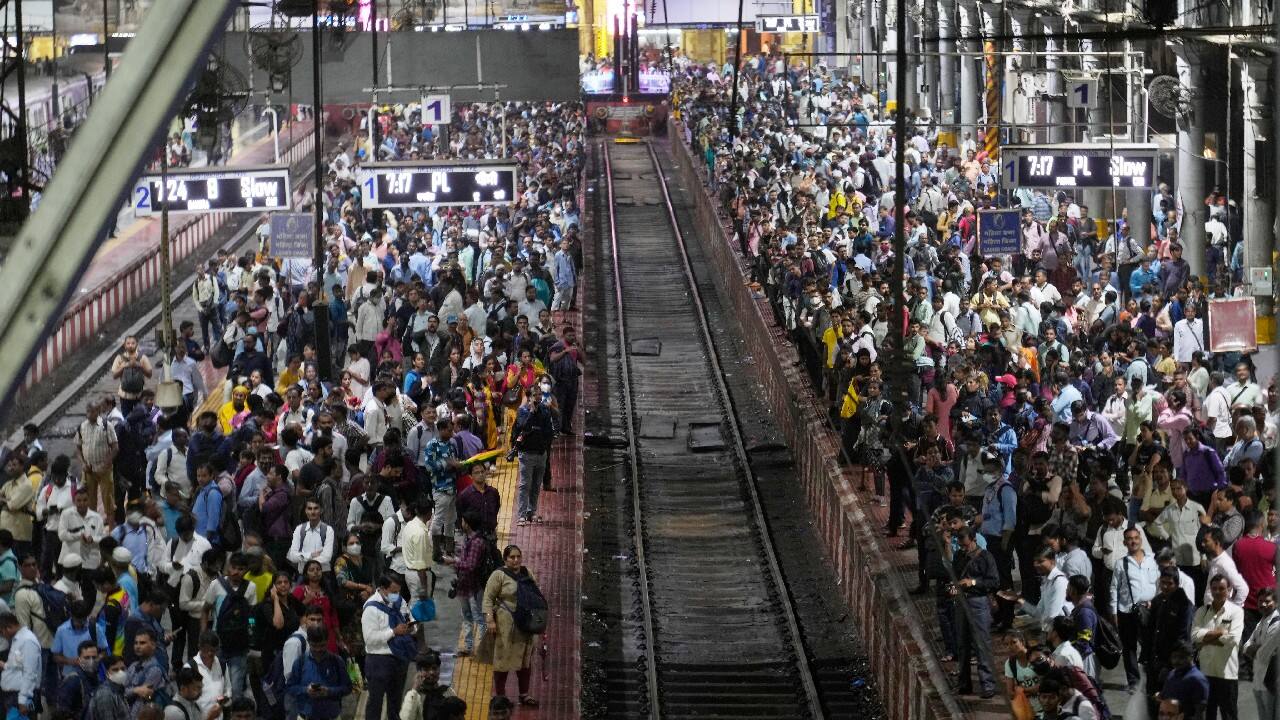 People wait for local trains, delayed because of heavy rainfall, at Chhatrapati Shivaji Maharaj Terminus in Mumbai. (Image: AP)