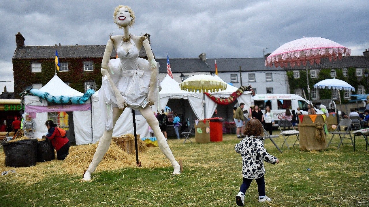 A child walks past a Marilyn Monroe themed scarecrow entered into the Ireland scarecrow championship during the Durrow Scarecrow Festival, in Durrow, Ireland, July 27. (Image: Reuters)