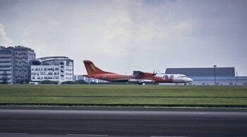 A flight from Malaysia lands at Seletar Airport.