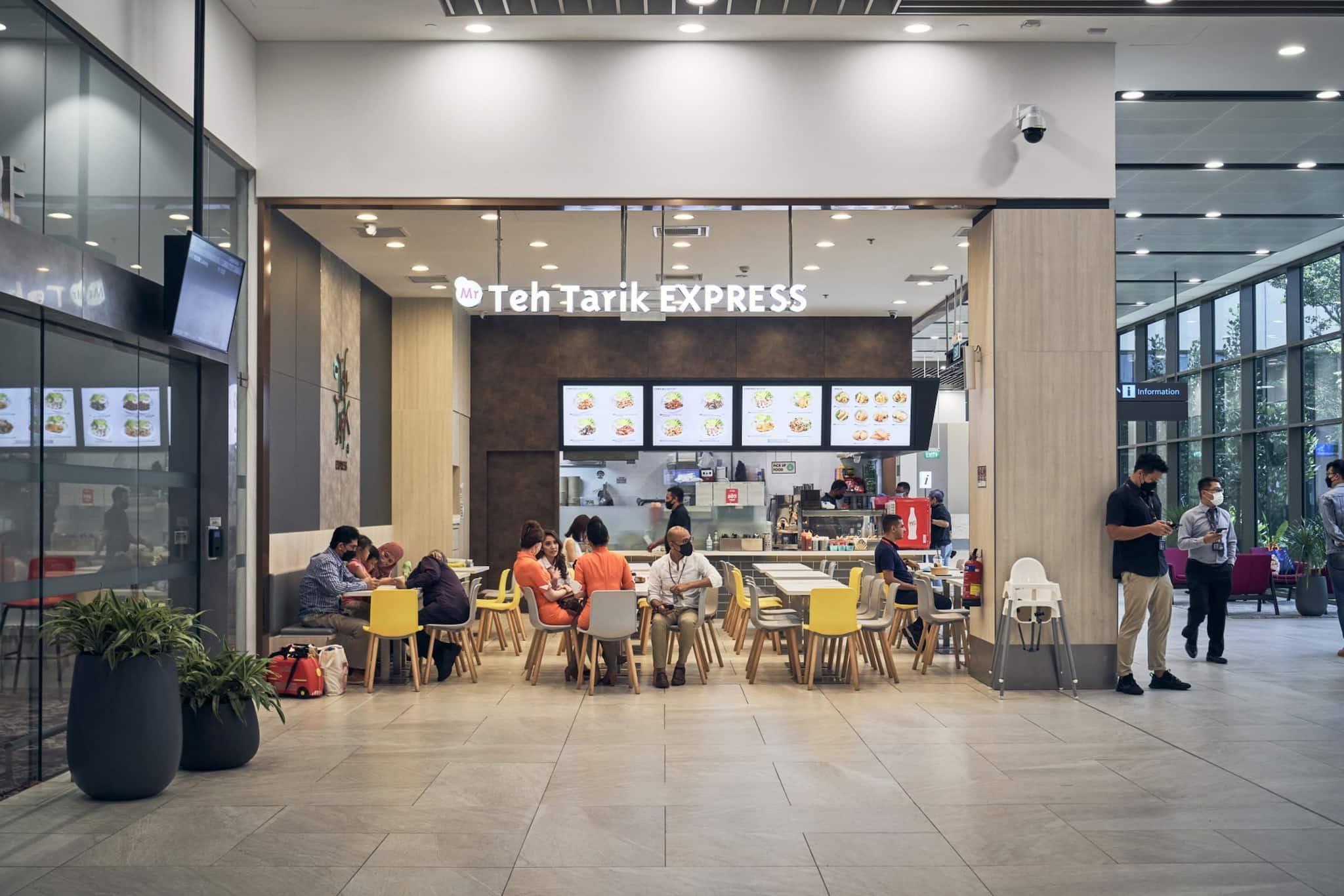 Patrons dine at a cafe inside the departure hall at Seletar Airport.