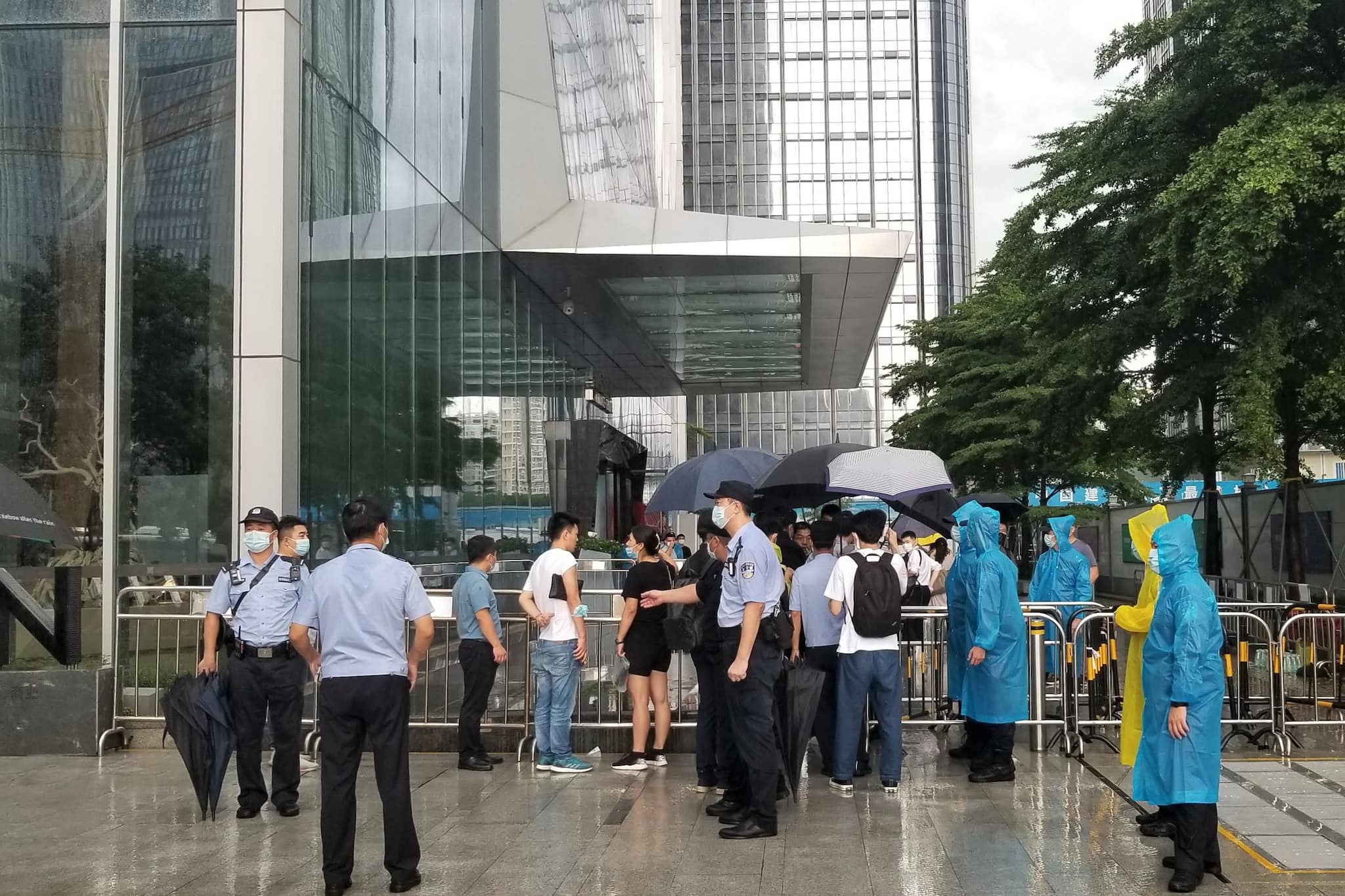 Police officers and security guards at the China Evergrande Group headquarters in Shenzhen in Sept. 2021 following mounting protests by homebuyers.