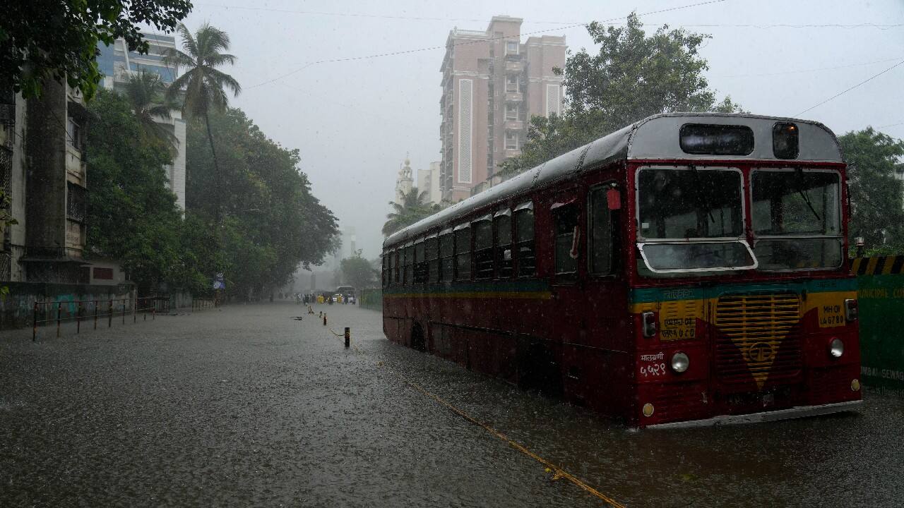 A bus stands stranded in a waterlogged road during heavy rainfall in Mumbai. (Image: AP)