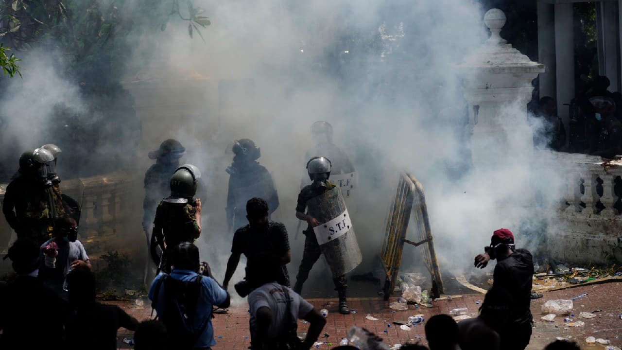Police fired tear gas to hold them back from overrunning the compound and officials declared a nationwide state of emergency &quot;to deal with the situation in the country&quot;, the prime minister's spokesman Dinouk Colombage told AFP. (Image: AP)
