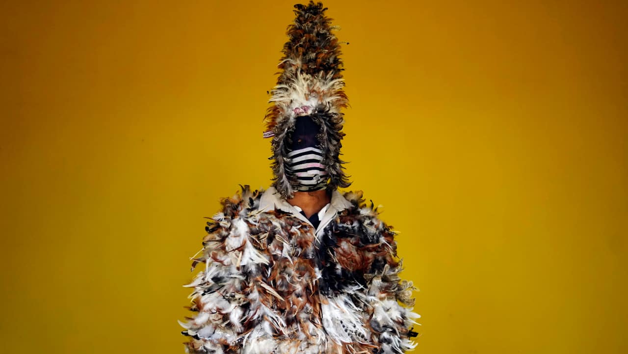 Osmar Aguero poses for a photo dressed in feathers to honor Saint Francisco Solano, known as the Saint of birds, during a Catholic Mass in Emboscada, Paraguay. Legend has it that while lying on his death bed in a Peruvian convent, birds perched on Solano's window and would sing to him, inspiring his followers to dress in bird costumes. 