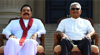 Former Sri Lankan leaders Gotabaya Rajapaksa (R) and his brother Mahinda Rajapaksa