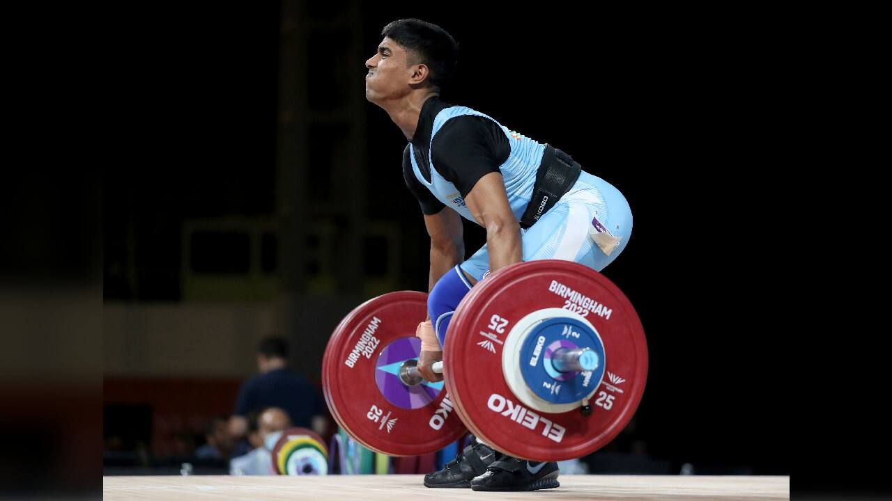 Silver medalist Sanket Mahadev Sargar in action during Men's 55kg Clean and Jerk weightlifting at The NEC on day two of the Commonwealth Games in Birmingham, England, July 30. Sanket lifted a total of 248kg to secure his silver medal. (Image: AP)
