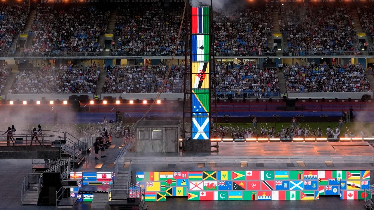 Artists perform as flags of Commonwealth countries are displayed during the Commonwealth Games closing ceremony at the Alexander stadium in Birmingham, England. (Source: AP)