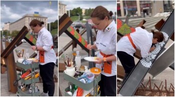 Ukrainian artist Varvara Logvin paints on an anti-tank obstacle in Kyiv. (Screengrabs from video shared by the artist on Facebook)