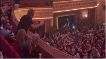 Australian Prime Minister Anthony Albanese gestures at the crowd after chugging his beer. (Screengrab from video shared by @rhanna_collins)