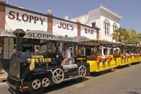 Visitors in Key West, Fla., ride the Conch Tour Train as it passes in front of Sloppy Joe's Bar, former watering hole of author Ernest Hemingway. The faux train and Old Town Trolley are two of the island's primary motorized tour operations. Key West is the southernmost city in the continental United States.  Photo by Bob Krist/Florida Keys News Bureau (Photo courtesy Florida Keys Tourism Council)