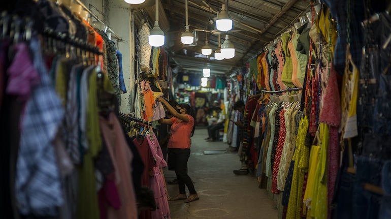 A shopper browses clothes in a market in Lucknow, India, on Wednesday, Oct. 13, 2021. The Reserve Bank of India expects the months-long festival season to bolster urban demand in the second half of the financial year to March 2022, while rural demand will likely be buoyed by a robust monsoon and record food grain production.