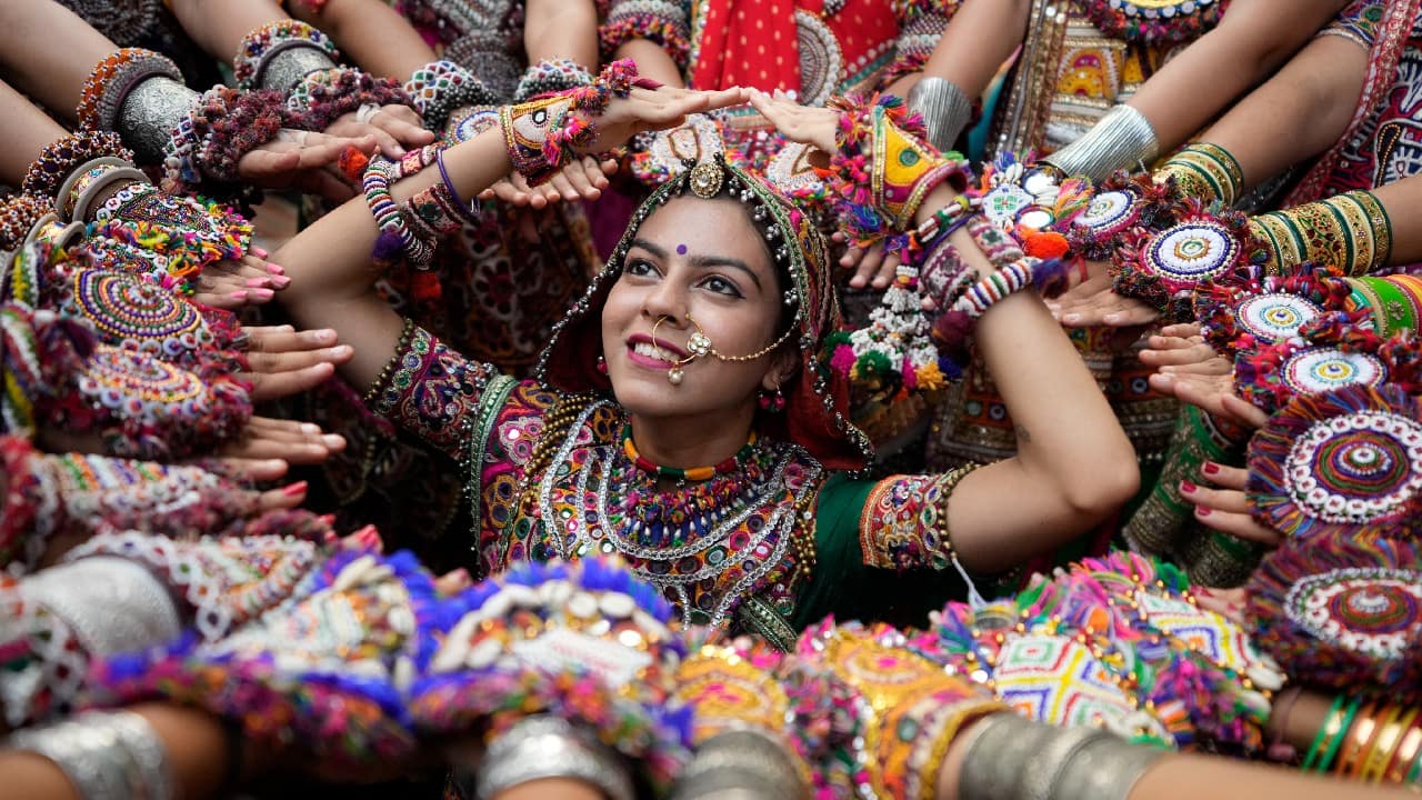 Women wearing traditional attire pose for photographs as they practice the Garba, the traditional dance of Gujarat state, ahead of Navratri in Ahmedabad, India, September 20. The Hindu festival of Navratri, or nine nights, will begin September 26. (Image: AP)
