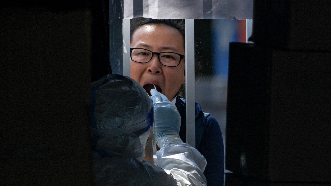 A man gets his routine COVID-19 throat swab at a coronavirus testing site in Beijing, September 21. (Image: AP)