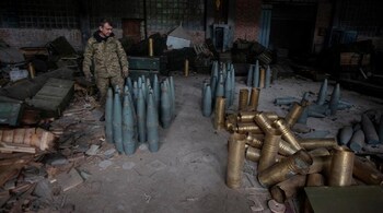 A Ukrainian service member checks Russia artillery shells captured during a counteroffensive operation near the town of Izium, September 14. (Source: Reuters)