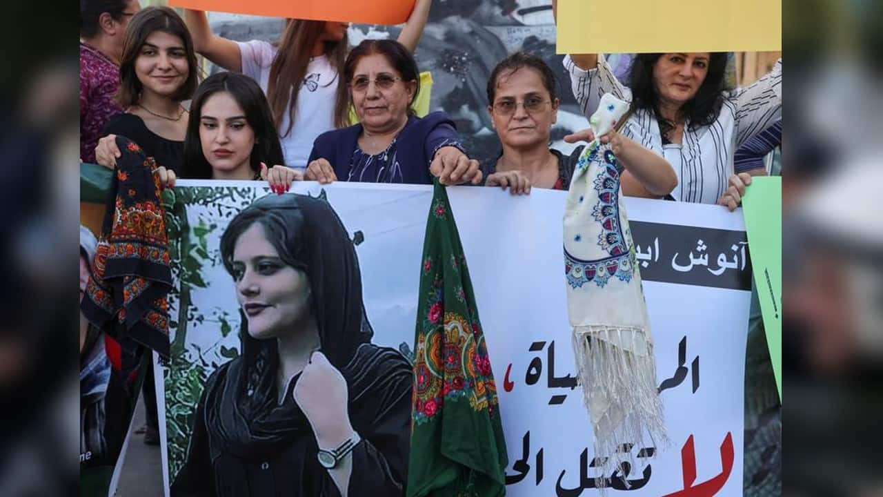 Women hold a picture of Mahsa Amini during a sit-in following her death, at Martyrs' Square in Beirut, Lebanon September 21. (Image: Reuters)