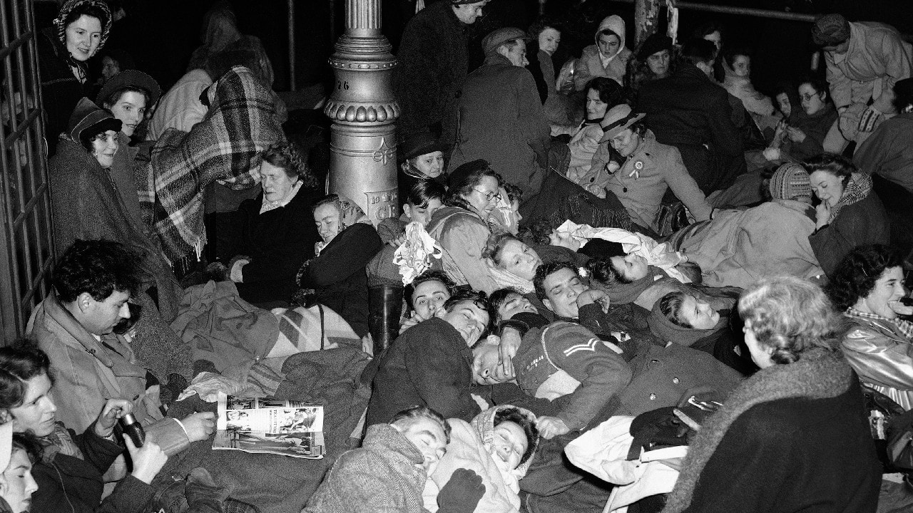 Huddled together on the pavement, opposite Westminster Abbey, London on November 20, 1947, these people made sure of their positions for the Royal procession for the wedding of Princess Elizabeth and the Duke of Edinburgh. (Image: AP)