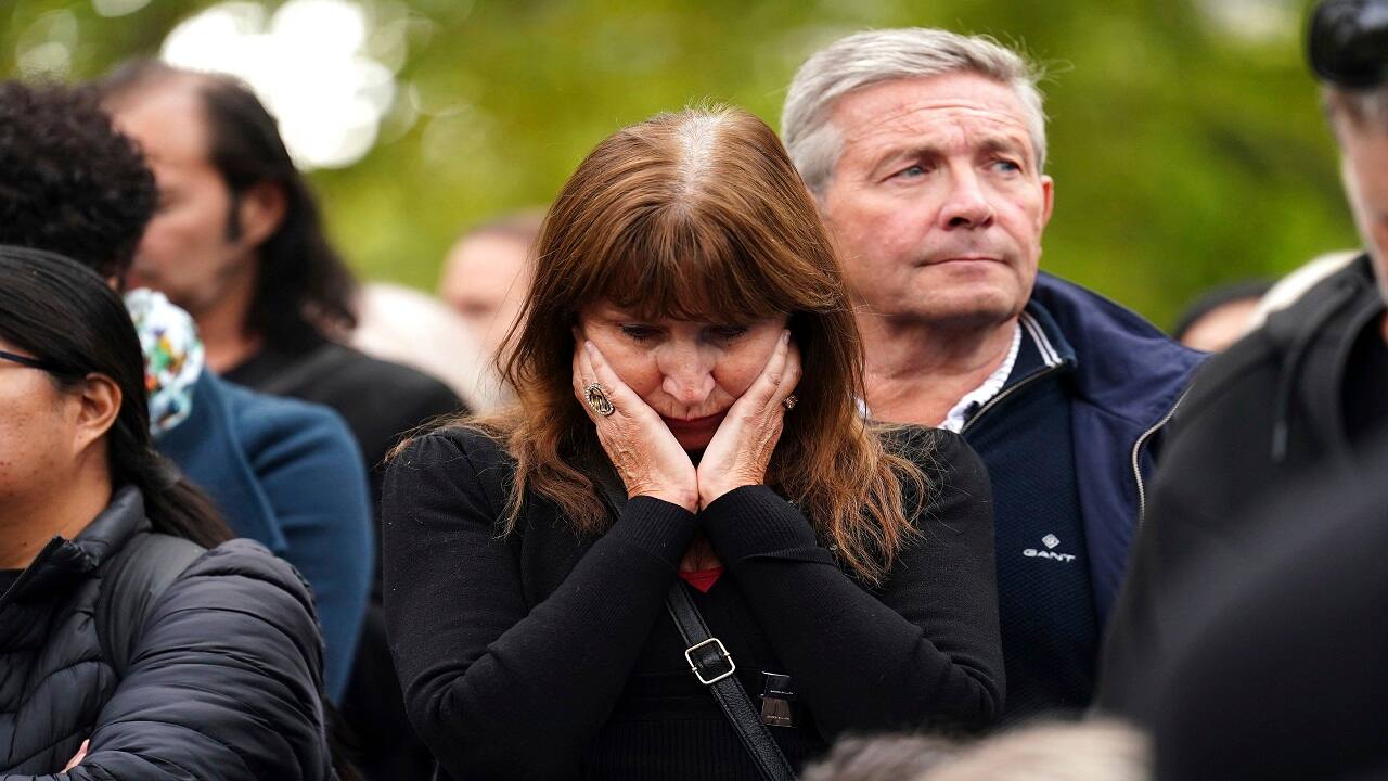 People react as the State Gun Carriage carrying the coffin of Queen Elizabeth II pass by during the Ceremonial Procession following her State Funeral at Westminster Abbey, London, Monday Sept. 19, 2022. (Mike Egerton/Pool Photo via AP)