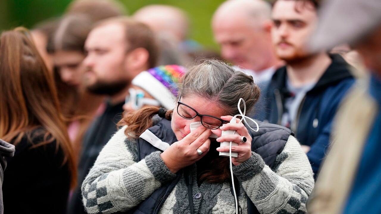 People react as the State Gun Carriage carrying the coffin of Queen Elizabeth II pass by during the Ceremonial Procession following her State Funeral at Westminster Abbey, London, Monday Sept. 19, 2022. (Mike Egerton/Pool Photo via AP)