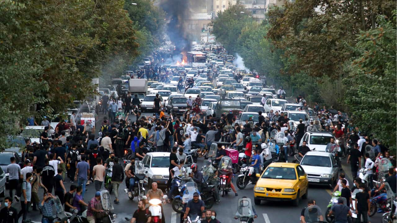 In this photo taken by an individual not employed by the Associated Press and obtained by the AP outside Iran, protesters chant slogans during a protest over the death of a woman who was detained by the morality police, in downtown Tehran, Iran