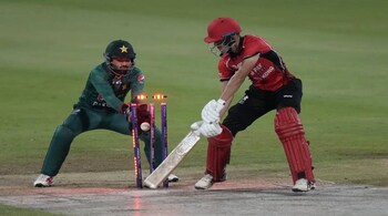 Hong Kong's Aizaz Khan looks bails shattered by Pakistan's Shadab Khan during the T20 match in Sharjah on Sept. 2, 2022. (AP Photo)