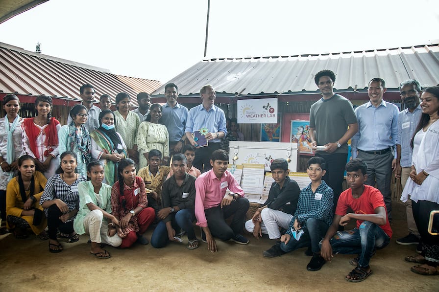Microsoft president Brad Smith (centre, left) and comedian Trevor Noah (centre, right) with students of the Vanphool community school in East Delhi, to pilot the Artificial Intelligence-led Sunny Lives disaster management model in September 2022. (Photo courtesy: Seeds)
