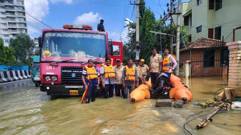 Rescuers and fire fighters pause for a moment
