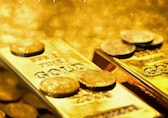 Gold set for third monthly rise on softer dollar, Fed slowdown bets