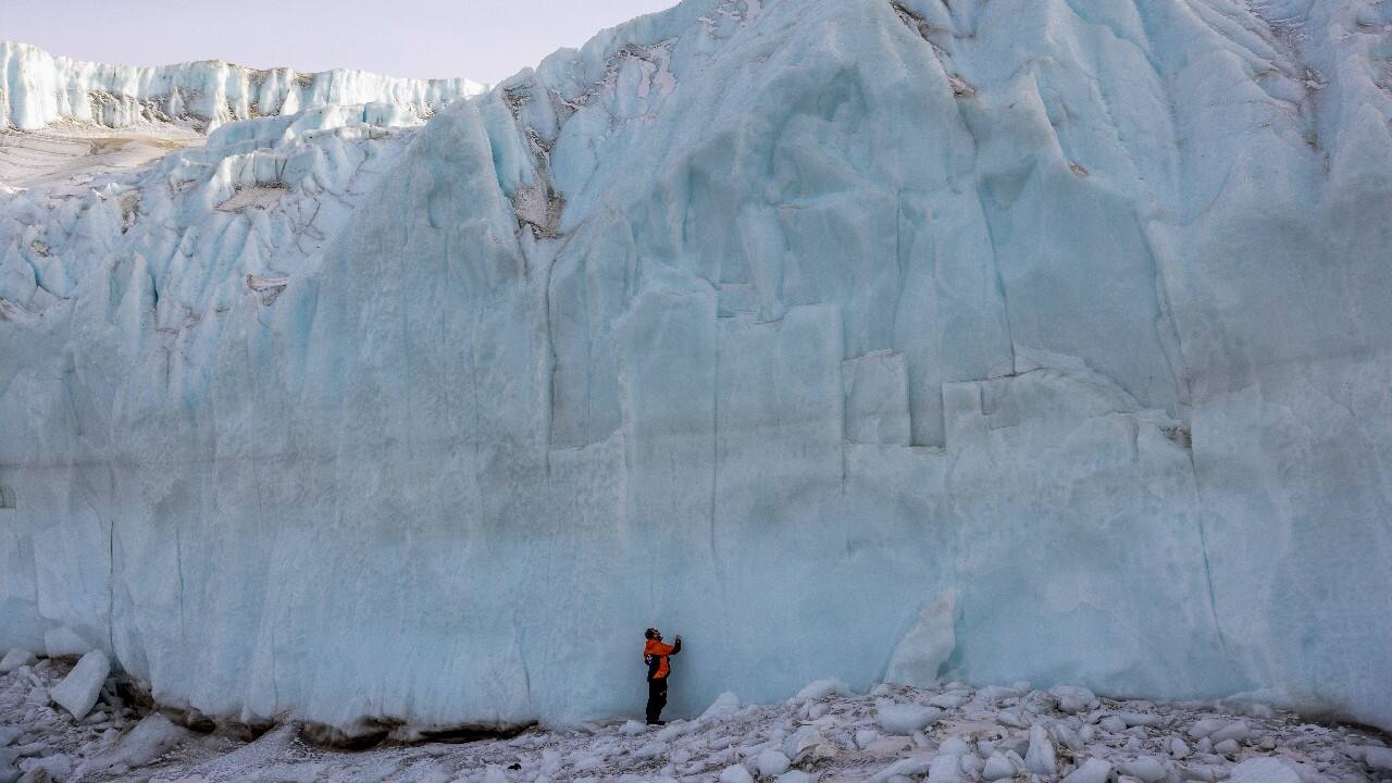 Shayne Misselbrook stands in front of a glacier in the Taylor Valley in Antarctica, October 27. (Mike Scott/NZ Herald via AP, Pool)