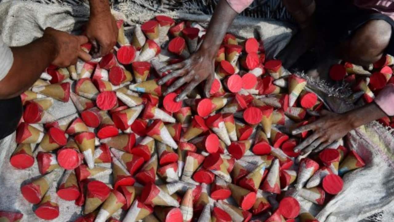 Workers lay out firecrackers for drying at a workshop ahead of Diwali on the outskirts of Ahmedabad.