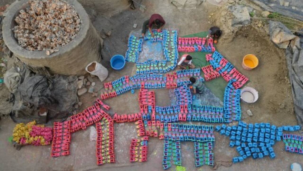 Potters paint earthen lamps ahead of Diwali in Jalandhar.