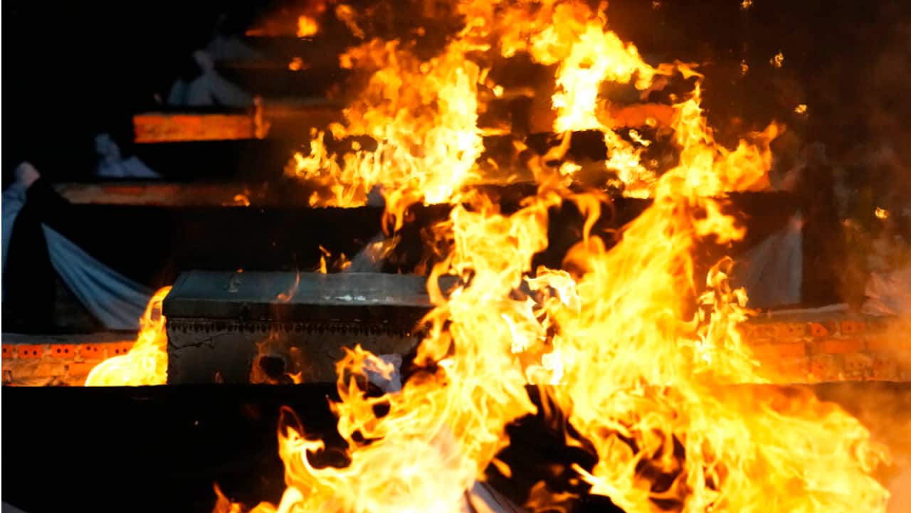 Funeral pyres cremate those who died in the day care center attack at Wat Rat Samakee temple in Uthai Sawan, northeastern Thailand.