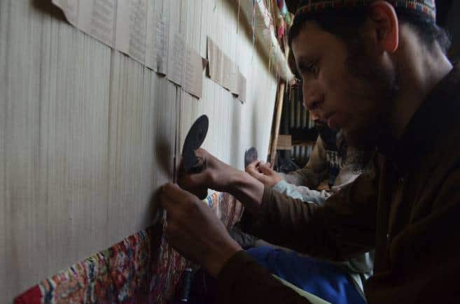The 50 master weavers have each been working 10 hours a day to complete the work. (Photo by Irfan Amin Malik)