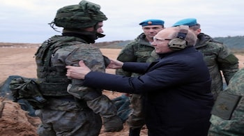 Russian President Vladimir Putin speaking to a soldier at a training camp outside the town of Ryazan on October 20. (Source: AFP/File)