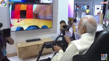 The prime minister was also seen driving a car virtually. The vehicle was an Ericsson booth in Sweden. (Image credit: PIB)